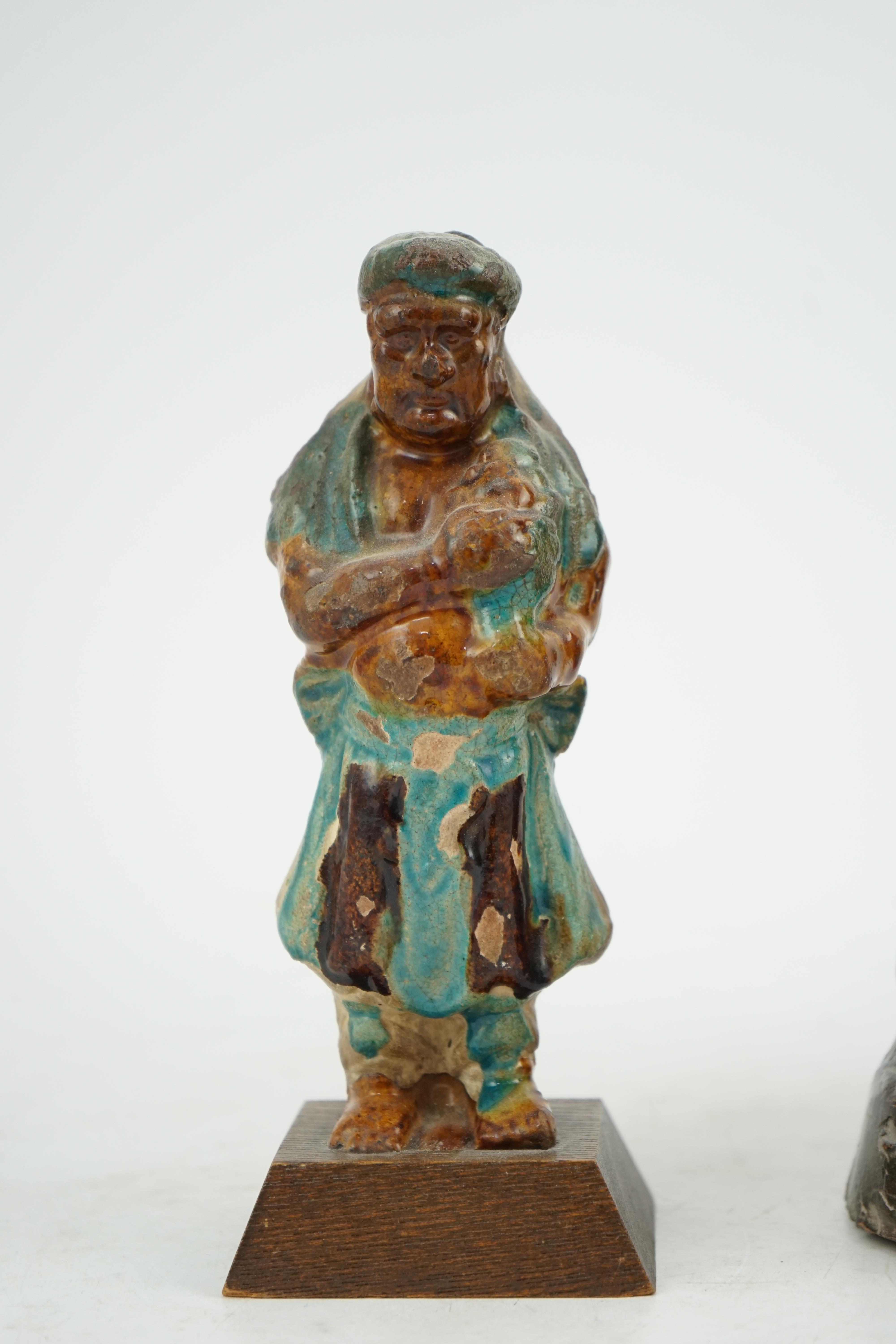 Two Chinese sancai glazed figures of a seated dignitary and a standing attendant, Ming dynasty